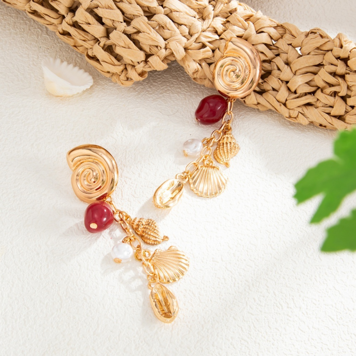 Marina gold-tone drop earrings with spiral studs, shell charms, deep red beads and pearl-look accents